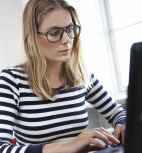 Woman in striped shirt by computer