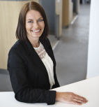 Lady advisor standing by desk